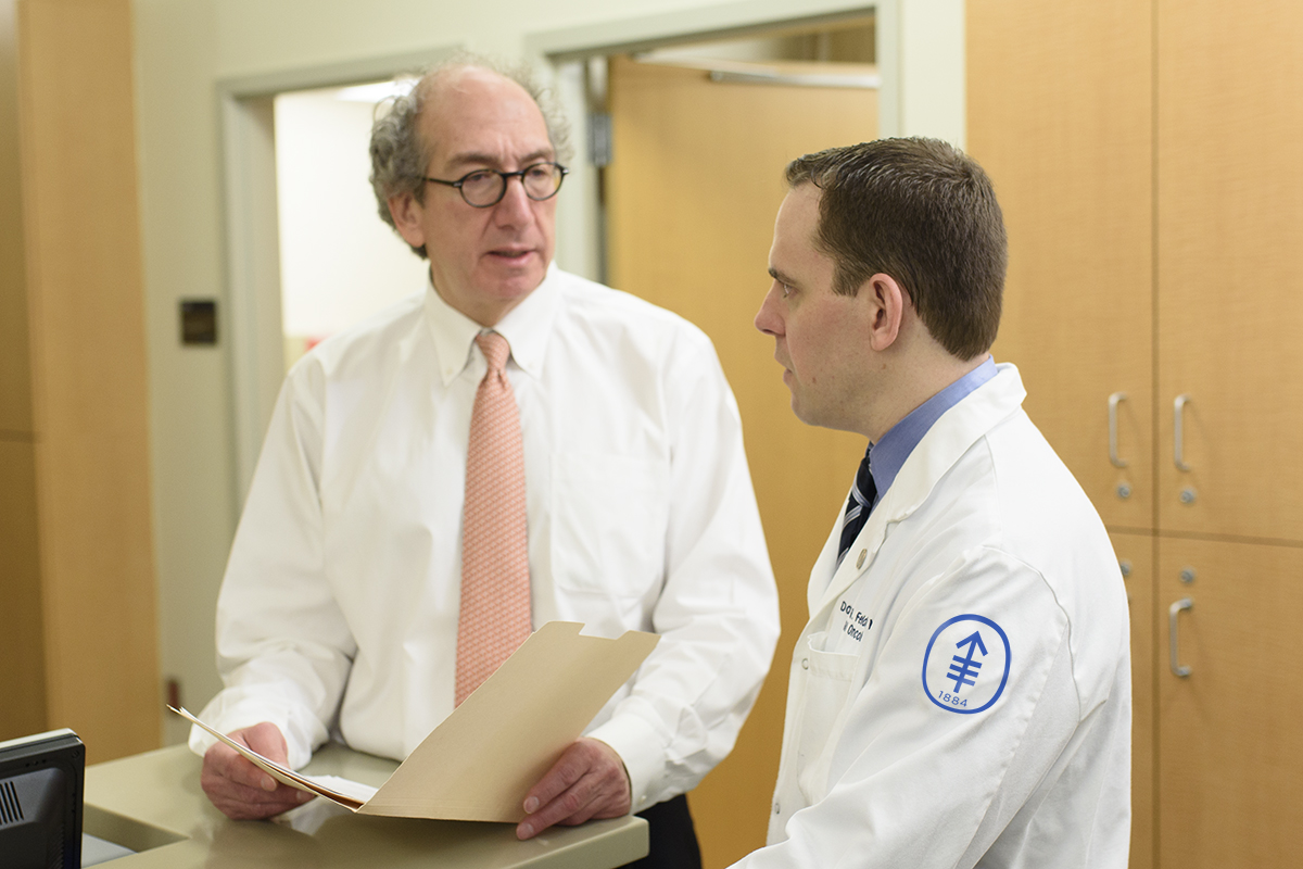 Urologic surgeon Joel Sheinfeld and medical oncologist Darren Feldman collaborate to provide a personalized treatment plan for a patient.