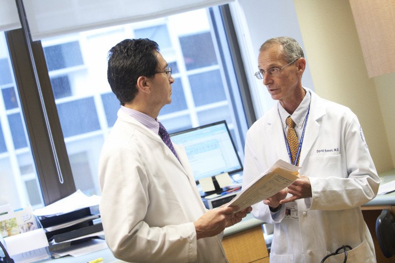 MSK medical oncologists Leonard Saltz (left) and David Paul Kelsen (right) speak to each other in an office.