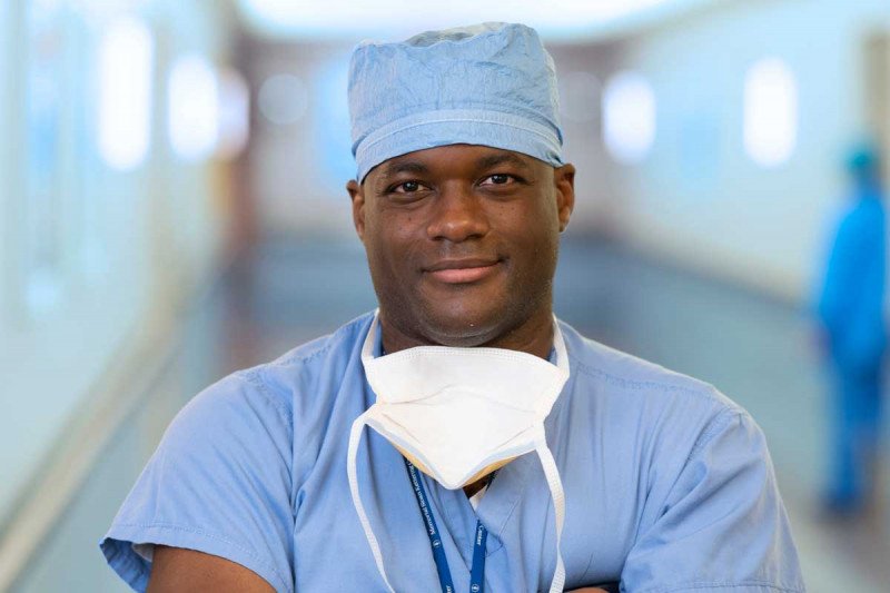 Man in surgical scrubs looks at reader