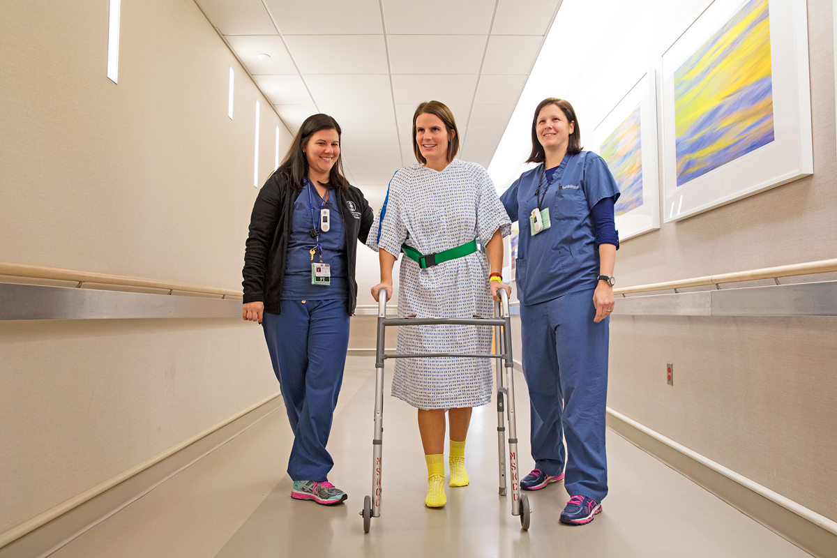 Patient and staff walking in Memorial Hospital