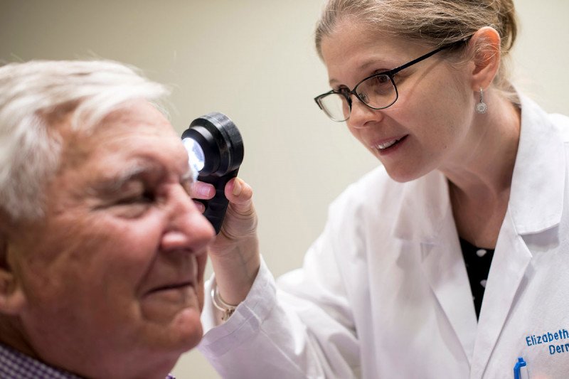 MSK dermatologist Elizabeth Quigley examines an older male patient