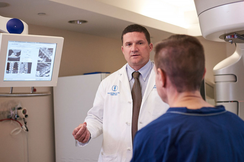 Memorial Sloan Kettering radiation oncologist Christopher Crane speaks with a patient.