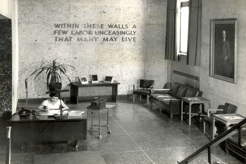 A view of the SKI lobby in 1949. The inscription reads: Within These Walls A Few Labor Unceasingly That Many May Live.